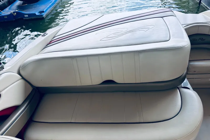 Slide: The Image of 2005 Sea Ray 200 Select boat interior with cushioned seating by the water. - 18