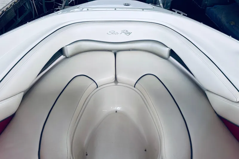 Slide: The Image of Interior seating of a 2005 Sea Ray 200 Select boat, featuring white upholstery. - 19
