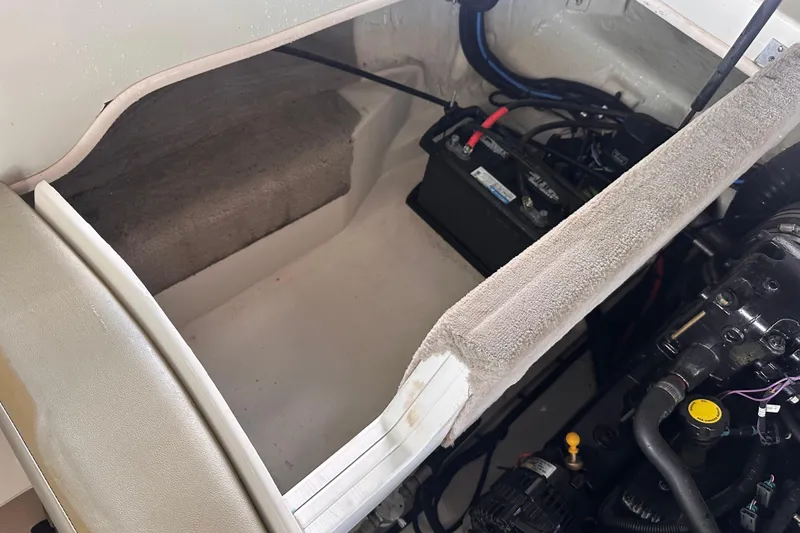 Slide: The Image of Engine compartment of a 2005 Sea Ray 200 Select boat, showing battery and components. - 22