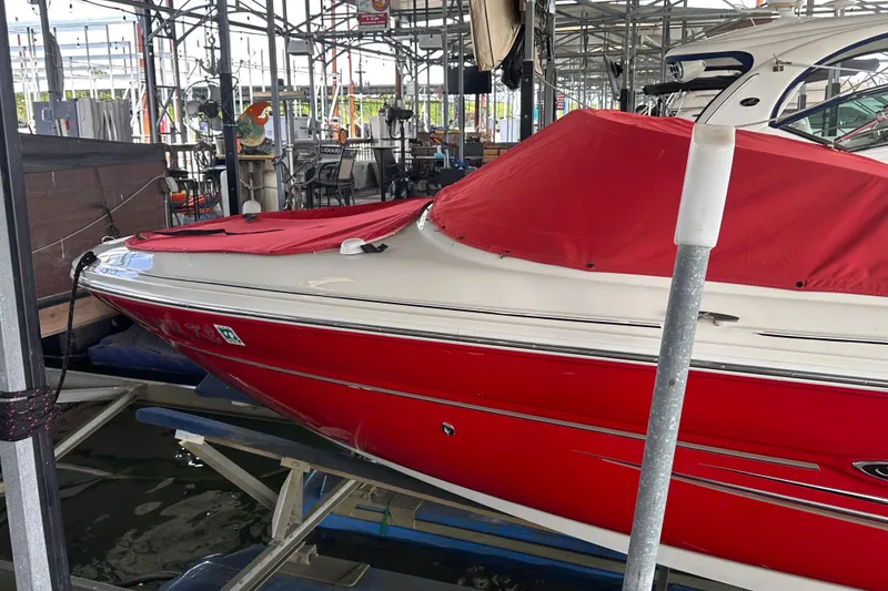 Slide: The Image of Red 2005 Sea Ray 200 Select boat with cover, docked in a marina. - 4