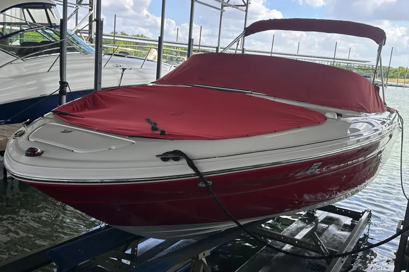 Slide: The Image of 2005 Sea Ray 200 Select boat with red cover docked on a lift. - 5