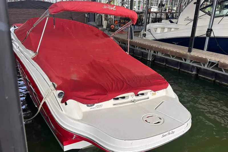Slide: The Image of 2005 Sea Ray 200 Select boat with red cover docked in marina. - 8
