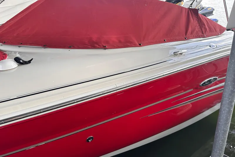 Slide: The Image of 2005 Sea Ray 200 Select boat with red cover and sleek design. - 9