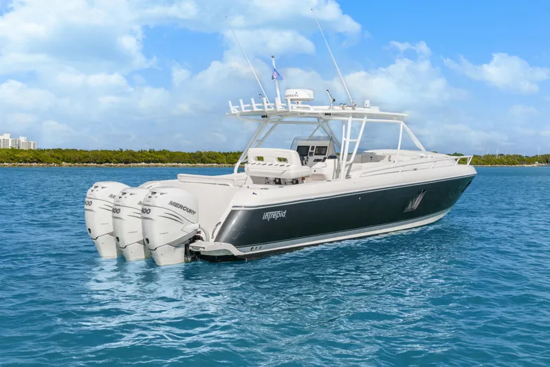 Slide: The Image of 2013 Intrepid 400 Cuddy boat with triple Mercury engines on blue water. - 10