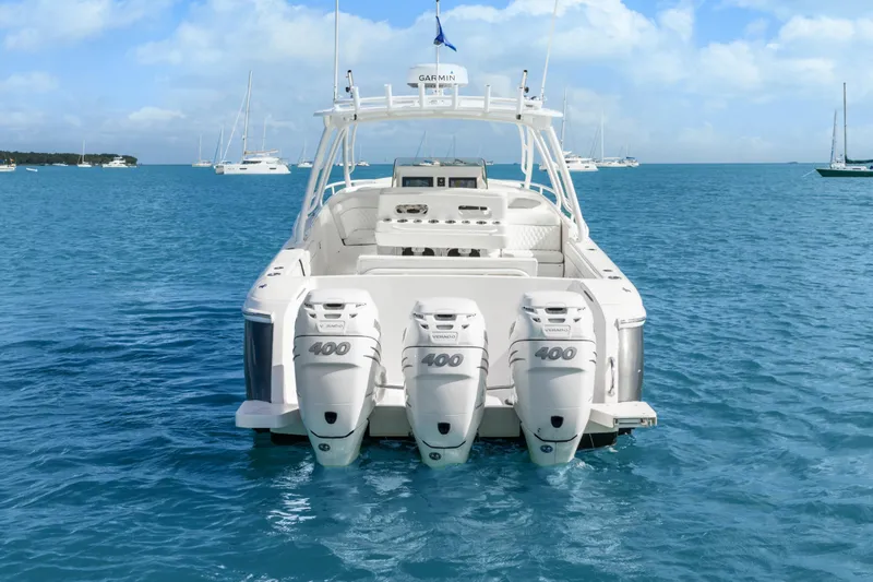 Slide: The Image of 2013 Intrepid 400 Cuddy boat with triple engines on blue ocean water. - 11