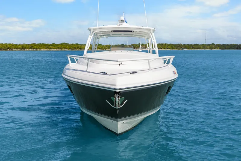 Slide: The Image of 2013 Intrepid 400 Cuddy boat on clear blue water, front view. - 14