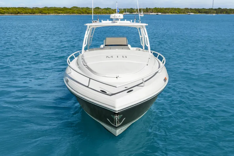 Slide: The Image of 2013 Intrepid 400 Cuddy boat on clear blue water, front view. - 15