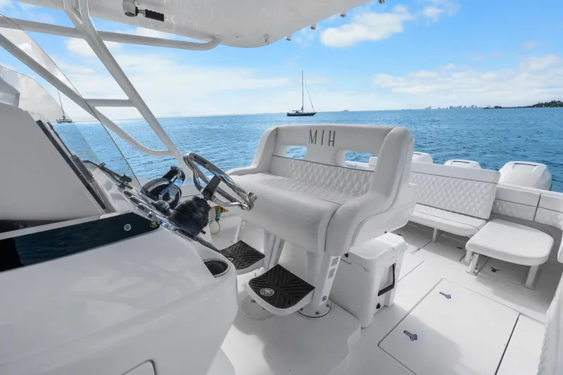 Slide: The Image of 2013 Intrepid 400 Cuddy boat interior with white seating and ocean view. - 21