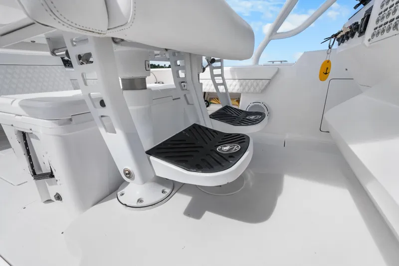 Slide: The Image of 2013 Intrepid 400 Cuddy boat interior with white seating and black footrests. - 22