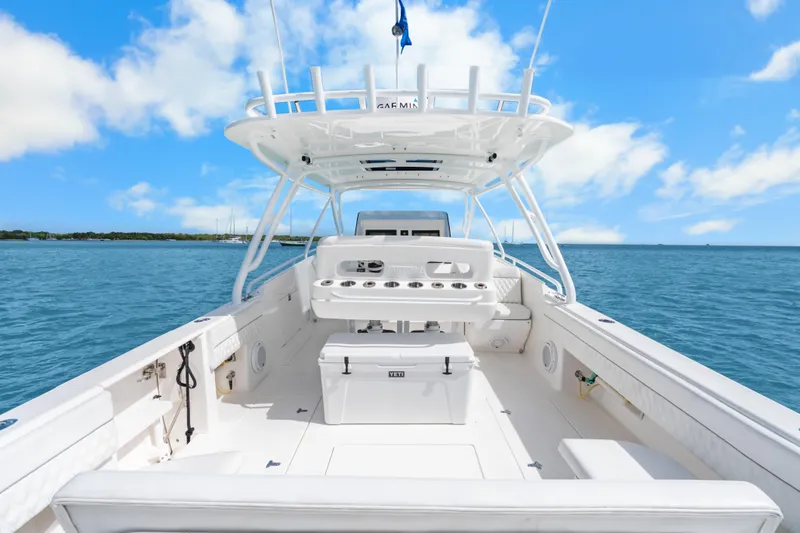 Slide: The Image of 2013 Intrepid 400 Cuddy boat on open water under clear blue sky. - 23