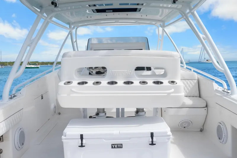 Slide: The Image of 2013 Intrepid 400 Cuddy boat interior with seating and Yeti cooler on deck. - 24