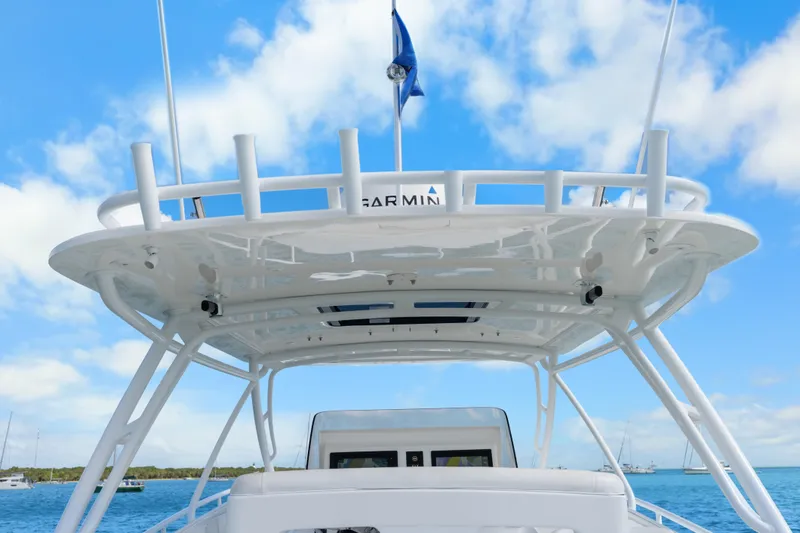 Slide: The Image of 2013 Intrepid 400 Cuddy boat with Garmin equipment, under a clear blue sky. - 25
