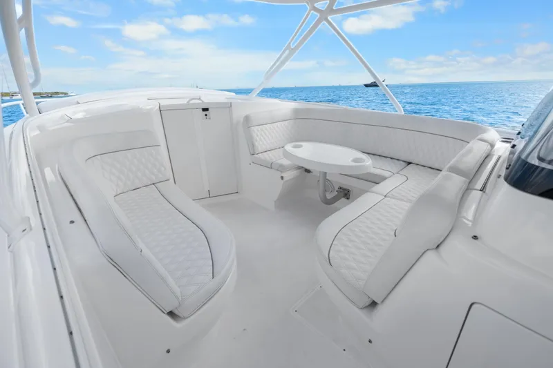 Slide: The Image of Luxurious 2013 Intrepid 400 Cuddy boat interior with white seating and ocean view. - 26