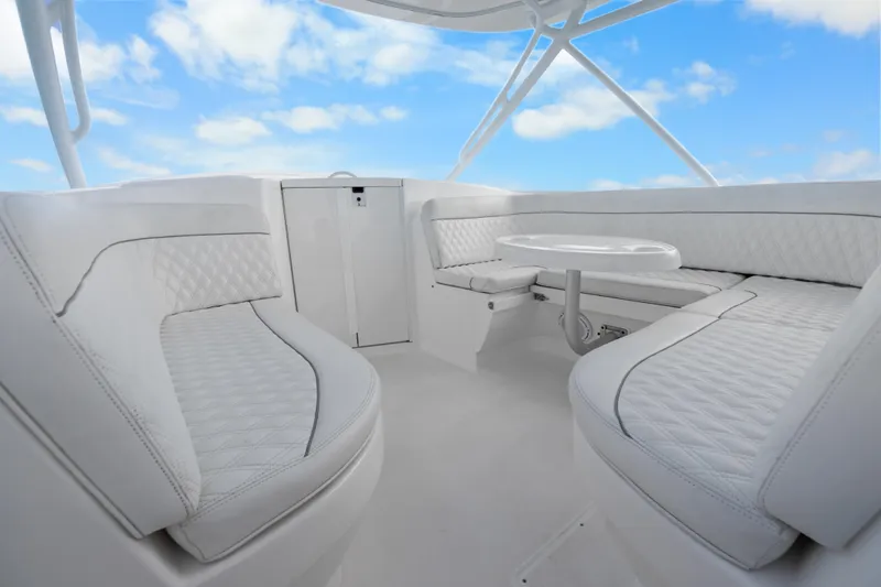 Slide: The Image of Luxurious white seating area on 2013 Intrepid 400 Cuddy boat under blue sky. - 27