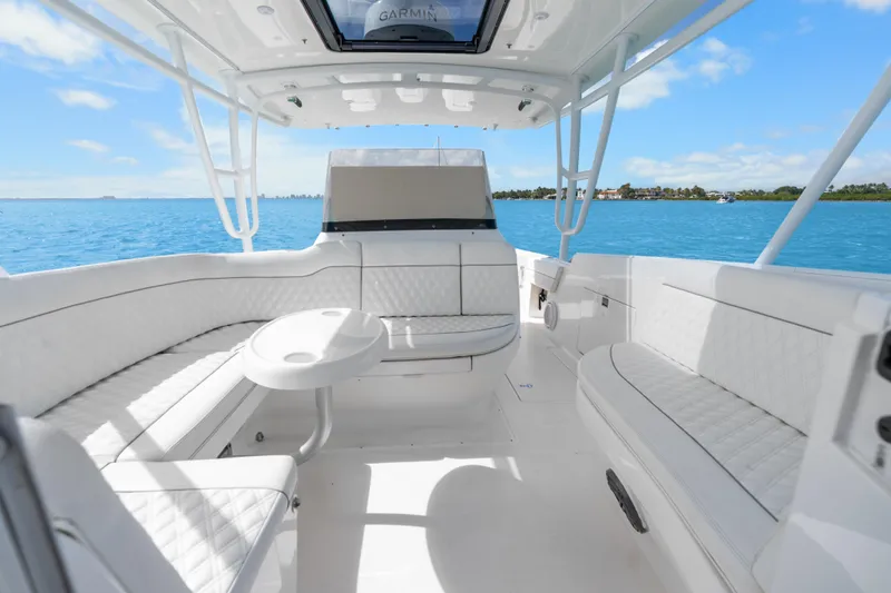 Slide: The Image of Luxurious 2013 Intrepid 400 Cuddy boat interior with white seating, cruising on blue waters. - 28