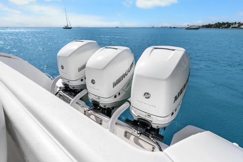 Slide: The Image of Triple Mercury outboard engines on a 2013 Intrepid 400 Cuddy boat in open water. - 35