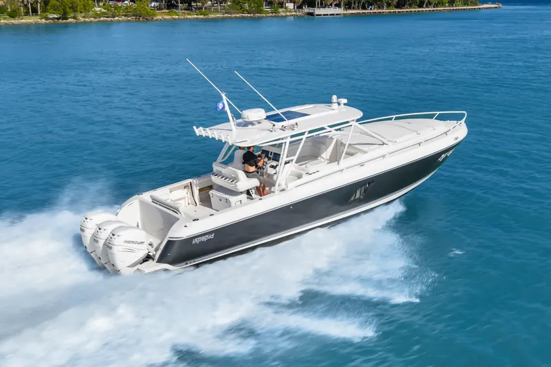 Slide: The Image of 2013 Intrepid 400 Cuddy cruising on blue water, showcasing sleek design and powerful engines. - 4