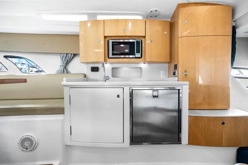 Slide: The Image of Interior of 2013 Intrepid 400 Cuddy featuring modern kitchenette with microwave and cabinetry. - 43