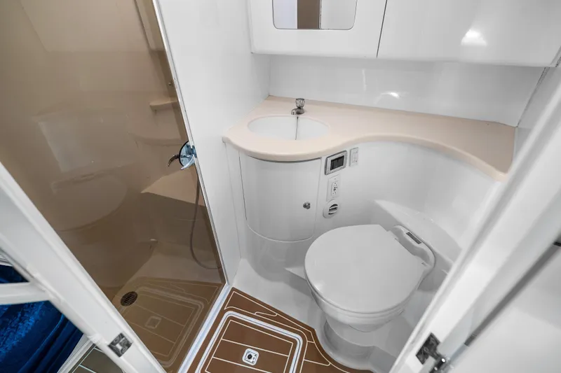Slide: The Image of Bathroom interior of 2013 Intrepid 400 Cuddy boat, featuring shower, sink, and toilet. - 45