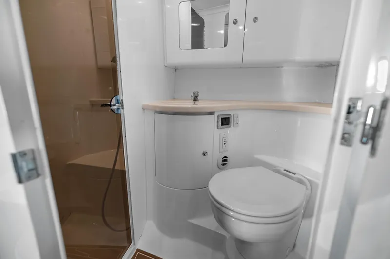 Slide: The Image of 2013 Intrepid 400 Cuddy boat bathroom with toilet, sink, and shower. - 46