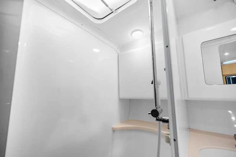 Slide: The Image of 2013 Intrepid 400 Cuddy boat interior bathroom with shower and mirror. - 47