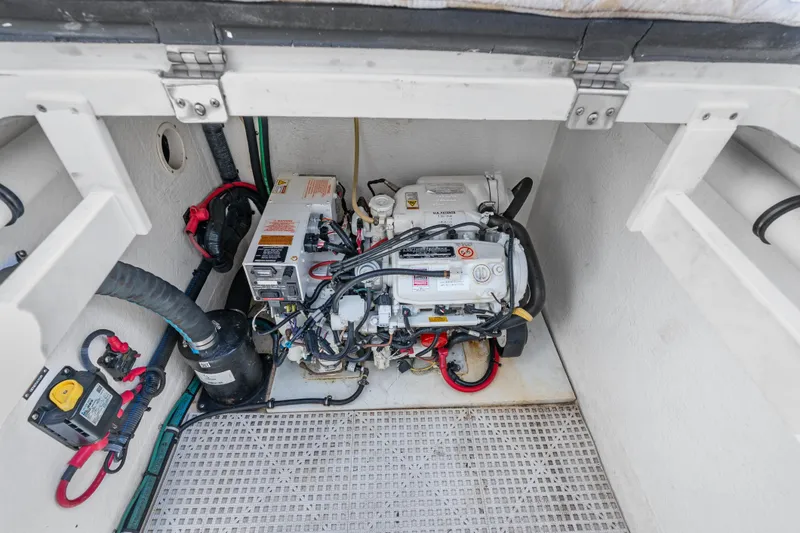 Slide: The Image of Engine compartment of a 2013 Intrepid 400 Cuddy boat, showcasing mechanical components. - 48