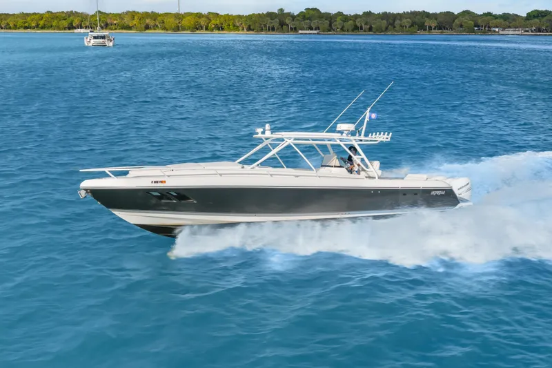 Slide: The Image of 2013 Intrepid 400 Cuddy cruising on blue water, showcasing sleek design and speed. - 5