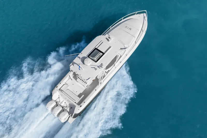 Slide: The Image of Aerial view of 2013 Intrepid 400 Cuddy boat cruising on clear blue water. - 6