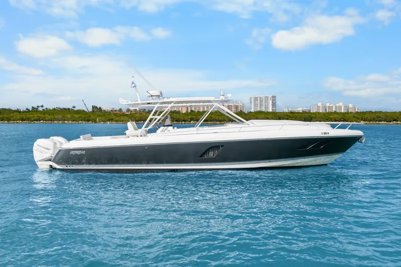 Slide: The Image of 2013 Intrepid 400 Cuddy boat on blue water with city skyline background. - 8