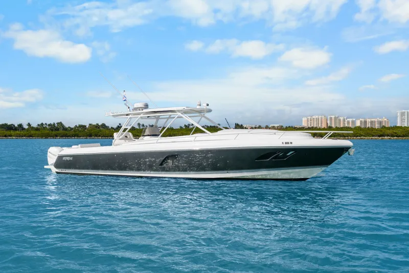 Slide: The Image of 2013 Intrepid 400 Cuddy boat on blue water with city skyline background. - 9