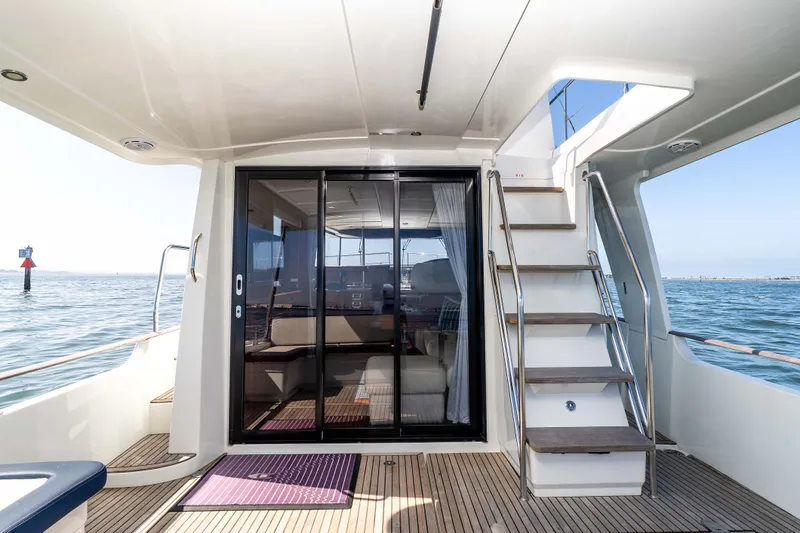 Slide: The Image of 2019 Beneteau Swift Trawler 44 with modern deck and stairs. - 25