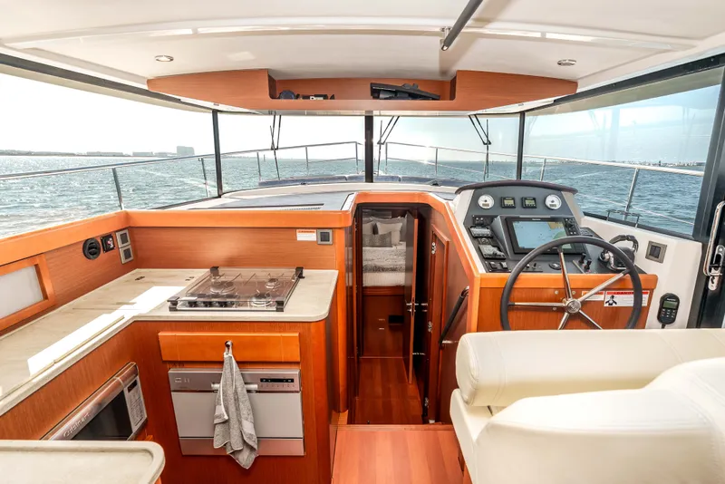 Slide: The Image of Interior of 2019 Beneteau Swift Trawler 44 with helm and kitchen area. - 31