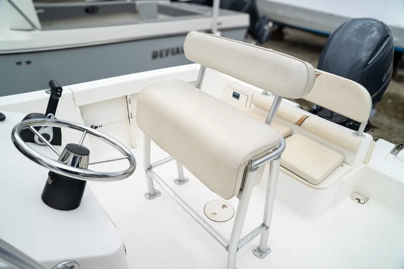 Slide: The Image of Interior of a 2004 Mako 192 boat with steering wheel and bench seat. - 5
