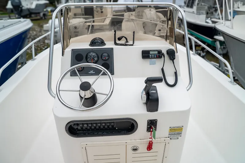 Slide: The Image of Steering console of a 2004 Mako 192 boat. - 6