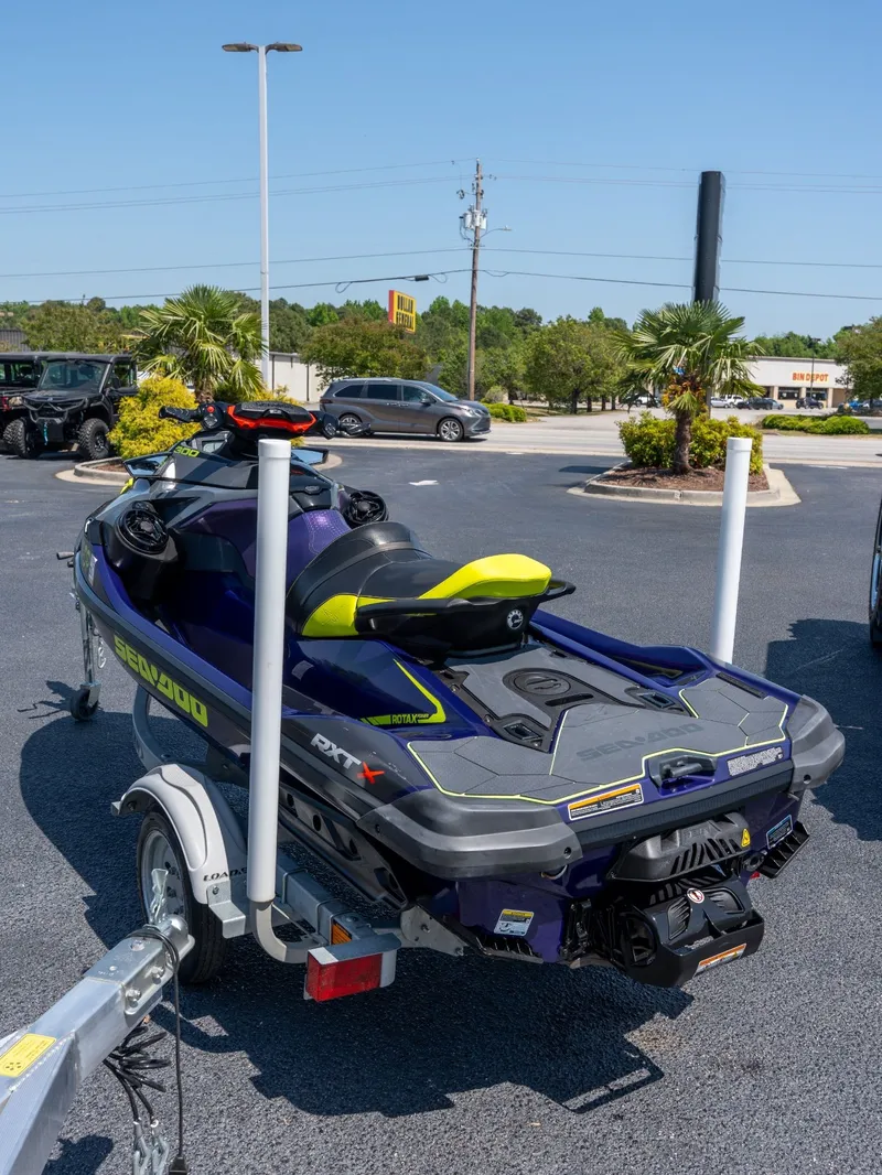 Slide: The Image of 2021 Sea-Doo RXT-X 300 IBR parked on trailer outdoors. - 4