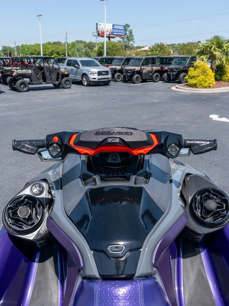 Slide: The Image of 2021 Sea-Doo RXT-X 300 IBR jet ski parked outdoors. - 7