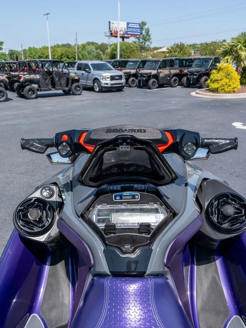 Slide: The Image of 2021 Sea-Doo RXT-X 300 IBR jet ski in parking lot. - 8