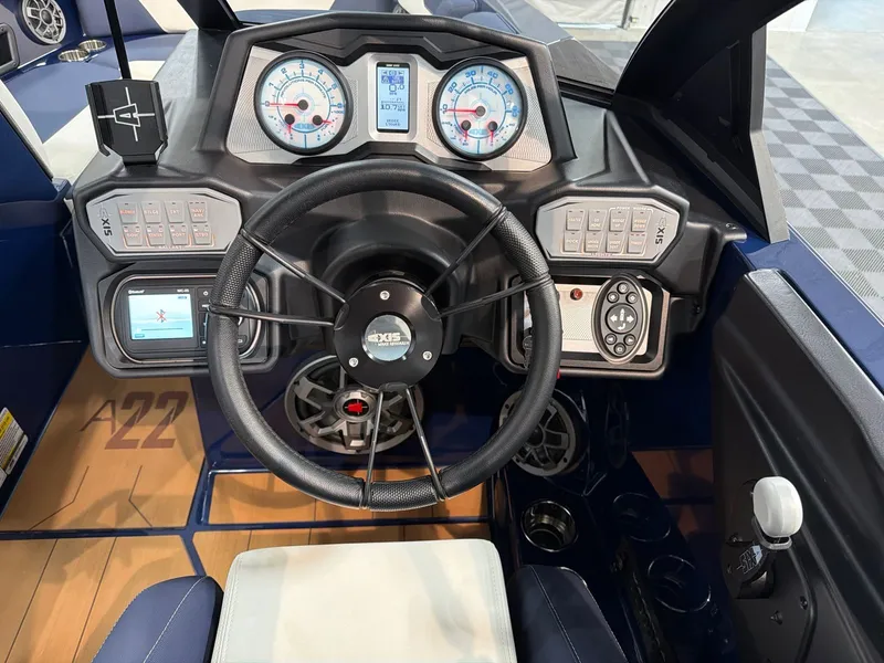 Slide: The Image of 2021 Axis A22 boat cockpit with steering and instruments. - 14