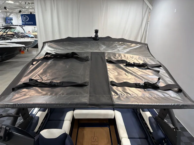 Slide: The Image of 2021 Axis A22 boat with cover in a showroom. - 19