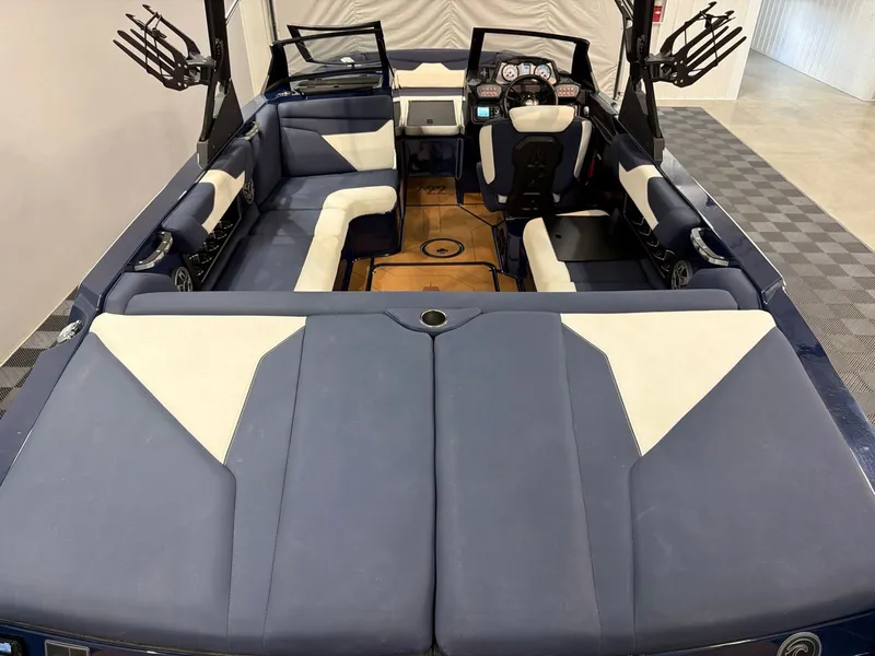 Slide: The Image of Interior of a 2021 Axis A22 boat with blue and white seating. - 6