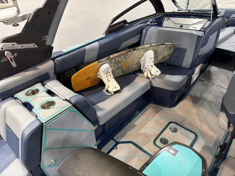 Slide: The Image of Interior of 2023 Malibu 26 LSV with wakeboard and cup holders. - 11
