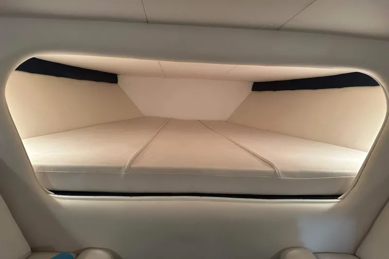Slide: The Image of Interior cabin of a 2007 Donzi 35 ZR boat with cushioned sleeping area. - 12