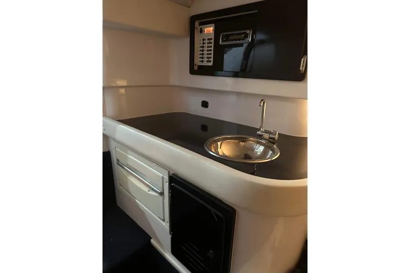 Slide: The Image of 2007 Donzi 35 ZR boat interior with sleek kitchenette and modern sink design. - 13