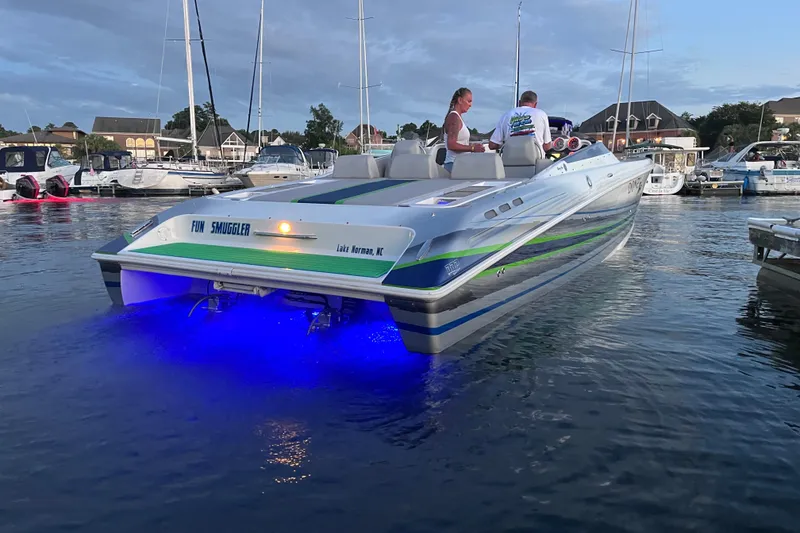 Slide: The Image of 2007 Donzi 35 ZR boat with blue underwater lights at a marina. - 16