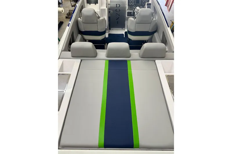 Slide: The Image of 2007 Donzi 35 ZR boat interior with gray, blue, and green seating. - 18