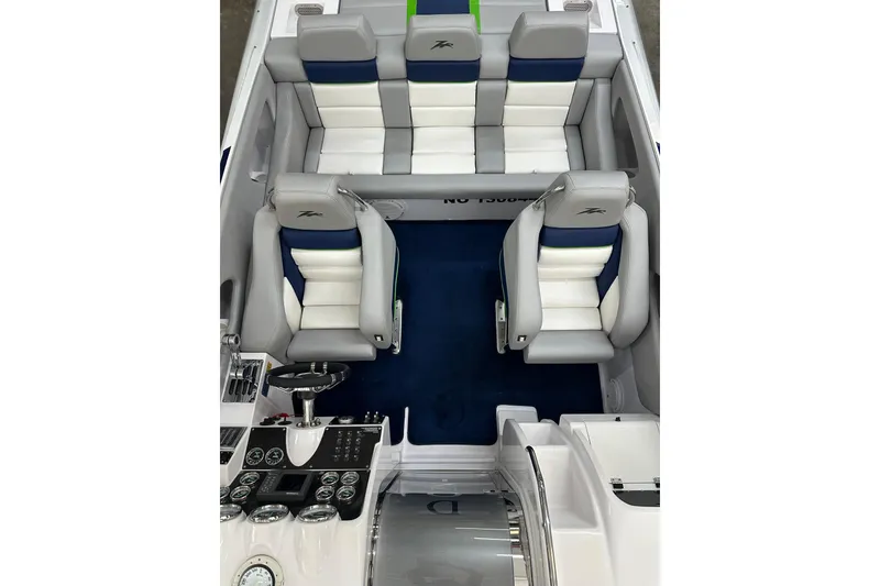 Slide: The Image of 2007 Donzi 35 ZR boat interior with white and blue seating, sleek dashboard. - 25