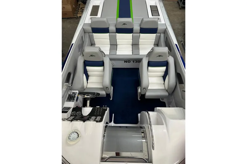 Slide: The Image of 2007 Donzi 35 ZR boat interior with white and blue seating, sleek design. - 26