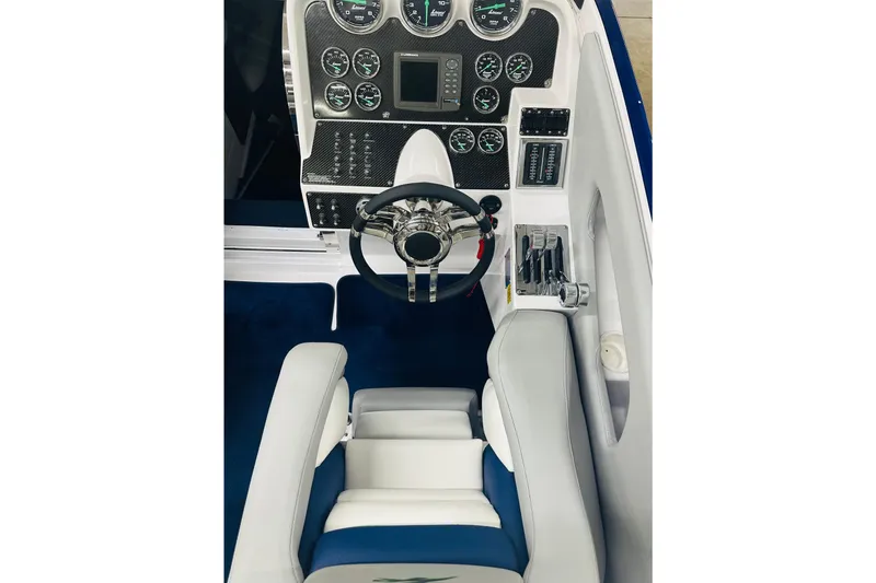 Slide: The Image of 2007 Donzi 35 ZR boat cockpit with steering wheel and instrument panel. - 27