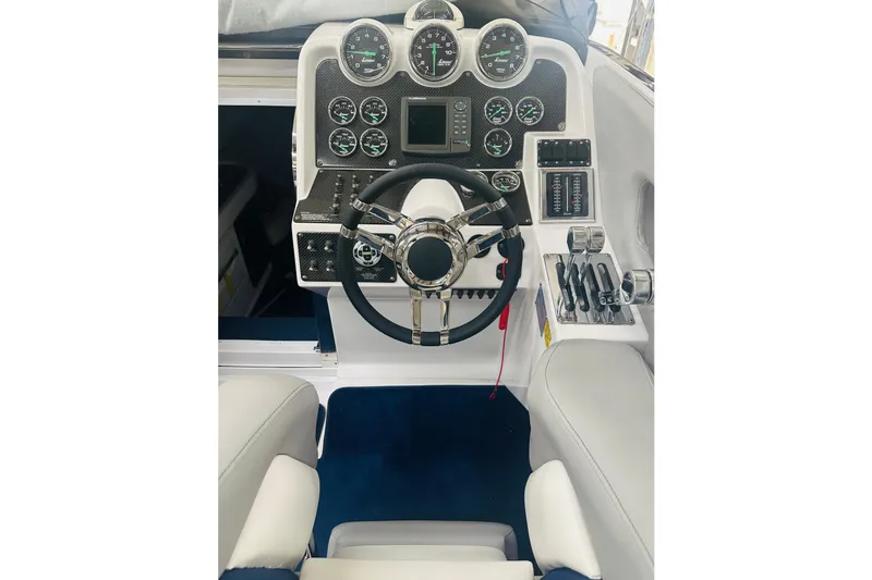 Slide: The Image of 2007 Donzi 35 ZR boat cockpit with steering wheel and control panel. - 28