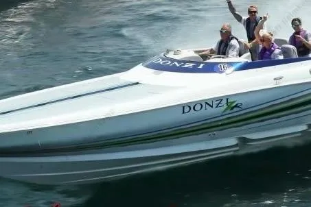 Slide: The Image of 2007 Donzi 35 ZR speedboat cruising with passengers on a sunny day. - 3